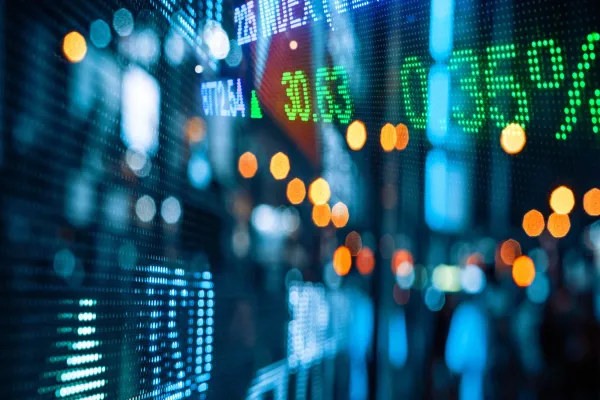 Display of Stock market quotes with city scene reflect on glass