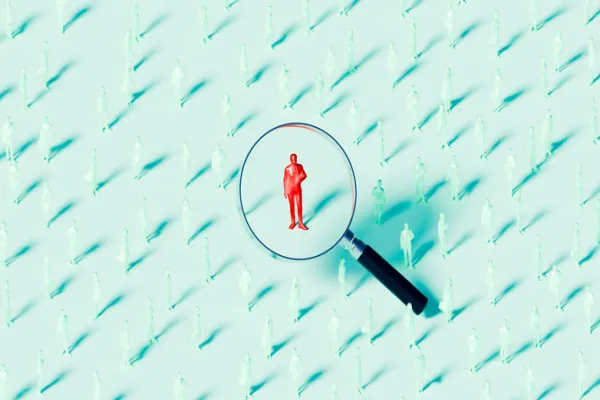 Businessman Under Magnifying Glass Concept of Recruitment and Selection - stock photo
