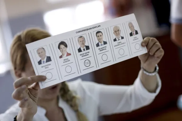 An election official displays a ballot in Turkey during last month's vote. (Kostas Tsironis/Bloomberg)