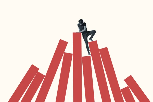 Young man climbing red bars