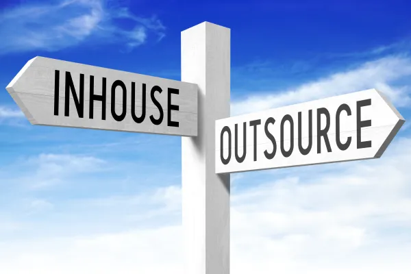 Outsource, inhouse - wooden signpost