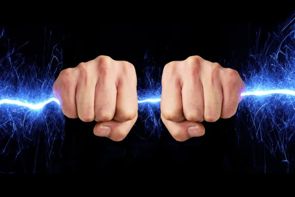 Hand holding blue sparks