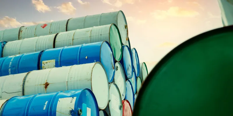 Old Chemical Barrels Stack. Red, Green, And Blue Chemical Drum. Steel Tank Of Flammable Liquid.