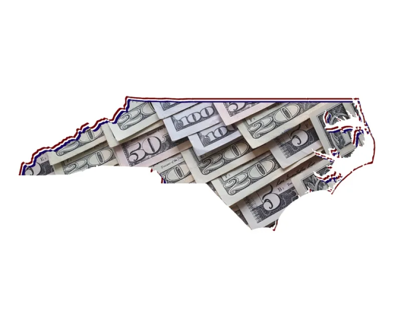 American dollar banknotes forming the map of North Carolina State and white background