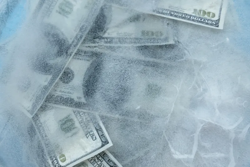 100 dollars frozen melt. Banknotes frozen in ice.