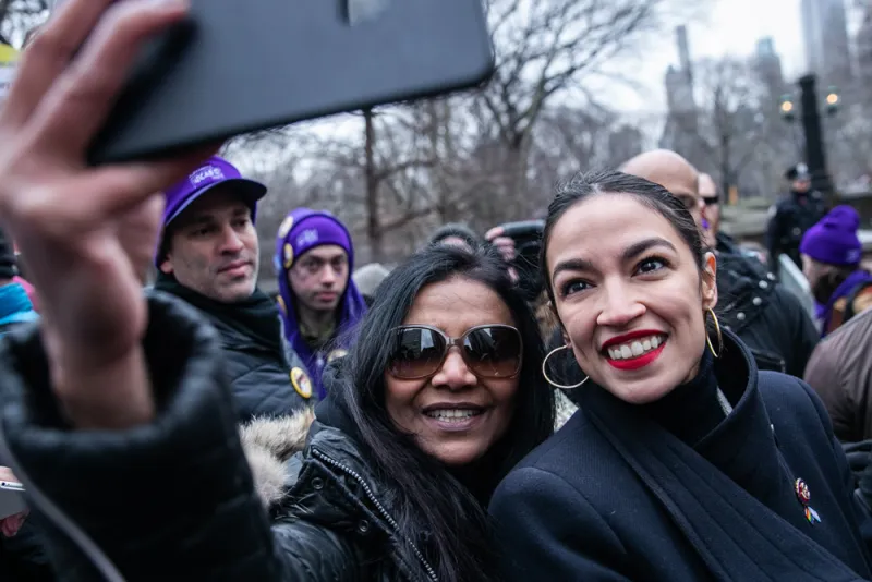 Representative Alexandria Ocasio-Cortez, takes a selfie with a demonstrator at the Women's March. (Jeenah Moon/Bloomberg)