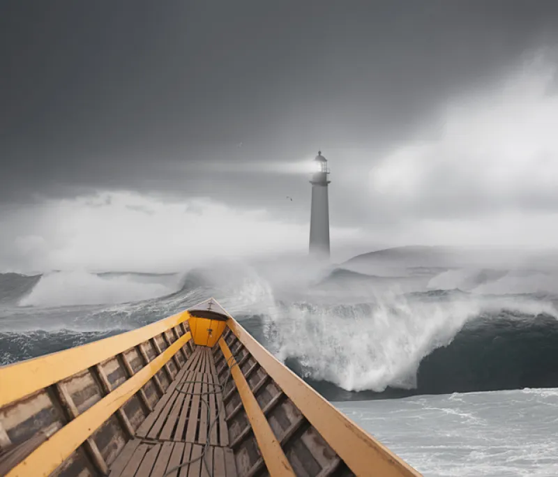 Boat sailing on stormy sea under lighthouse