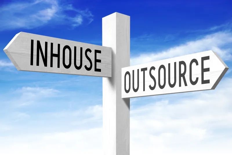 Outsource, inhouse - wooden signpost