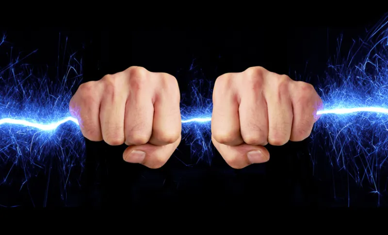 Hand holding blue sparks