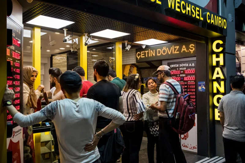 Tourists change money at a foreign currency bureau in Istanbul, Turkey. (Nicole Tung/Bloomberg)